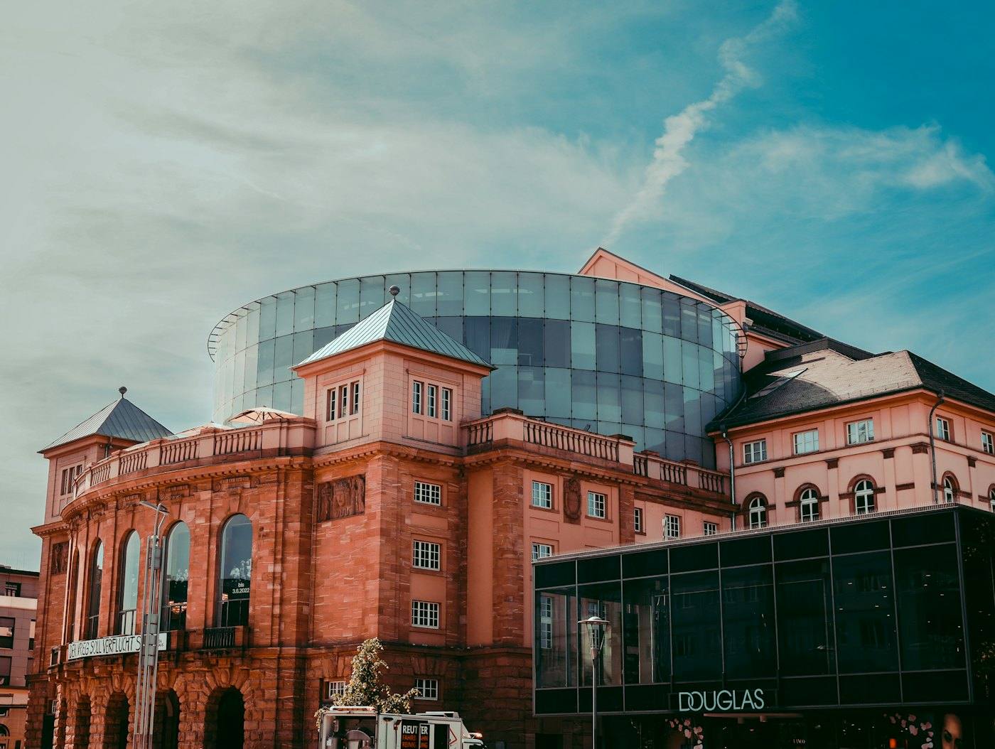 Red sandstone building with a glass dome