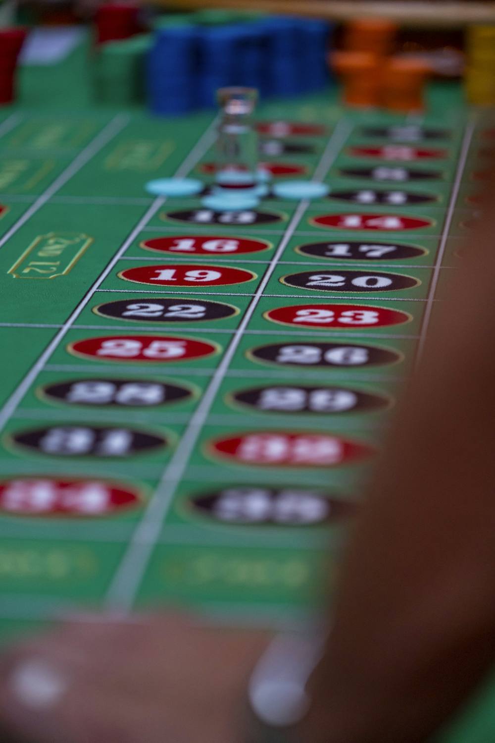 Green roulette table with number fields and chips